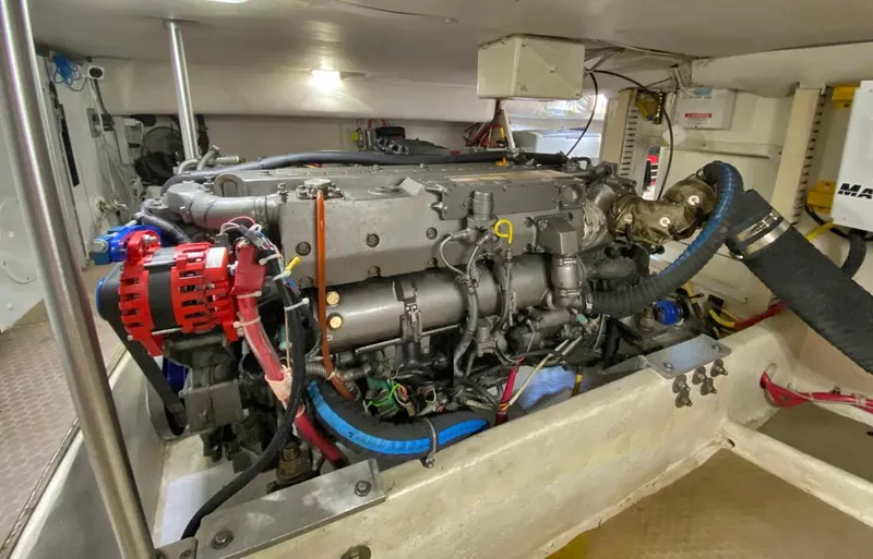 Slide: The Image of Engine room of a 2004 Mainship 340 boat, showcasing detailed mechanical components. - 19