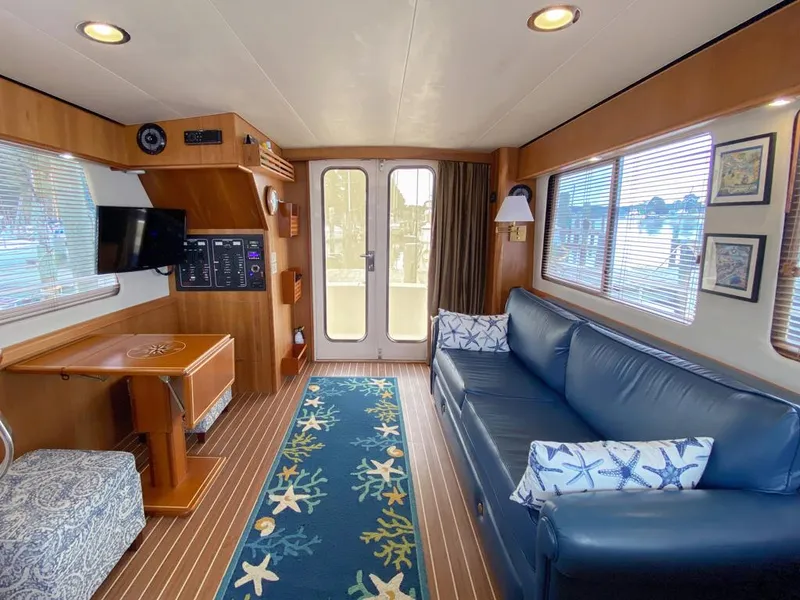 Slide: The Image of Interior of a 2004 Mainship 340 yacht with blue sofa and nautical decor. - 3