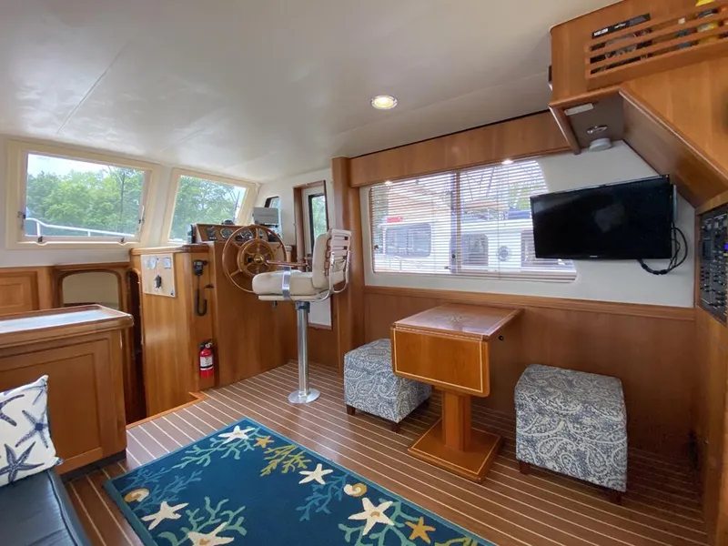 Slide: The Image of Interior of 2004 Mainship 340 yacht with helm, seating, and nautical decor. - 4