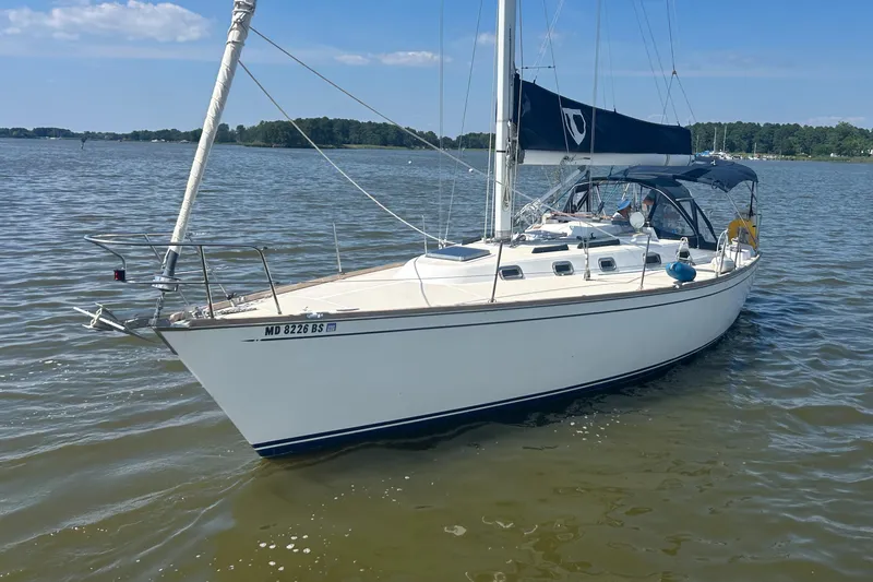 Slide: The Image of Sailboat Tartan 3500, 1998 model, anchored on calm water under a clear blue sky. - 1