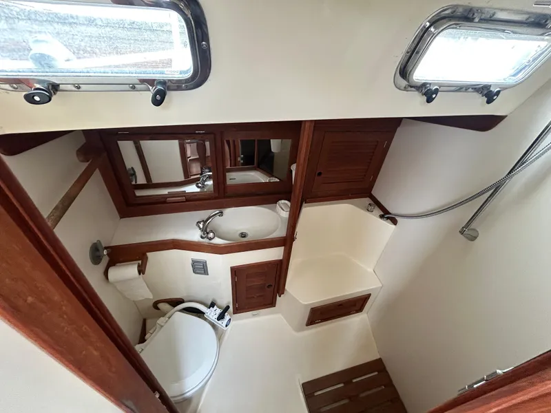 Slide: The Image of Compact bathroom in 1998 Tartan 3500 yacht with sink, toilet, and shower. - 16