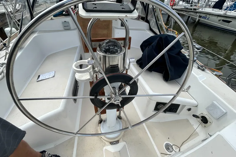 Slide: The Image of Cockpit of a 1998 Tartan 3500 sailboat with steering wheel and compass. - 25