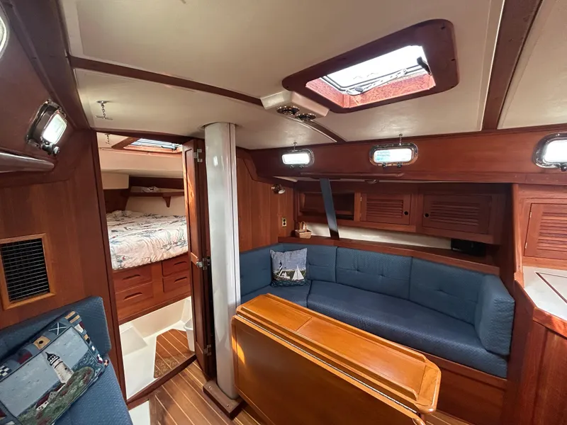 Slide: The Image of Interior of 1998 Tartan 3500 sailboat with cozy seating and wooden finishes. - 8