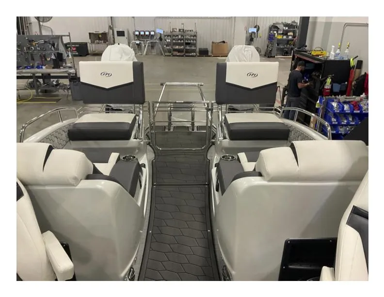 Slide: The Image of 2025 Manitou XT boat interior with luxurious seating in a manufacturing facility. - 5