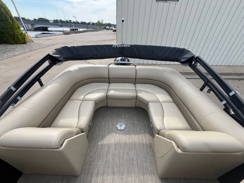 Slide: The Image of 2018 Manitou 23 Oasis RF VP pontoon boat with beige seating and black canopy. - 15