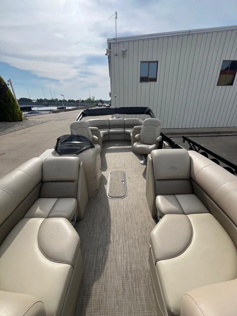 Slide: The Image of 2018 Manitou 23 Oasis RF VP pontoon boat with beige seating and spacious deck. - 5