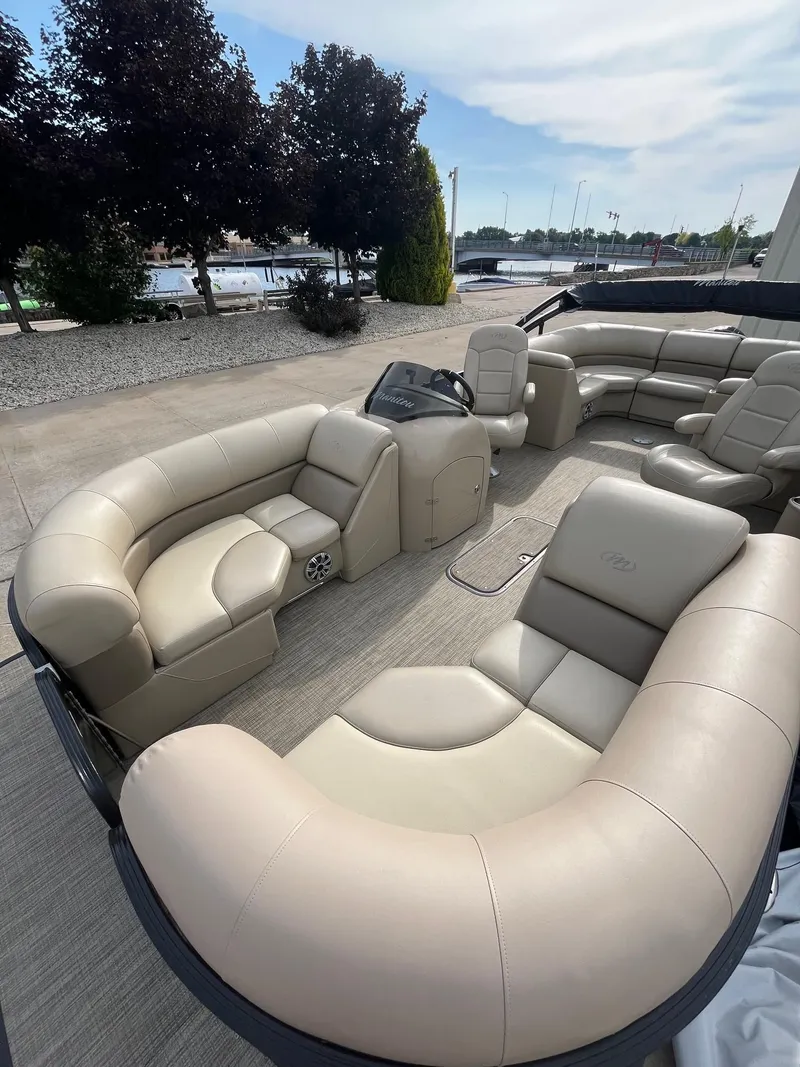 Slide: The Image of 2018 Manitou 23 Oasis RF VP pontoon boat with luxurious seating and modern design. - 6