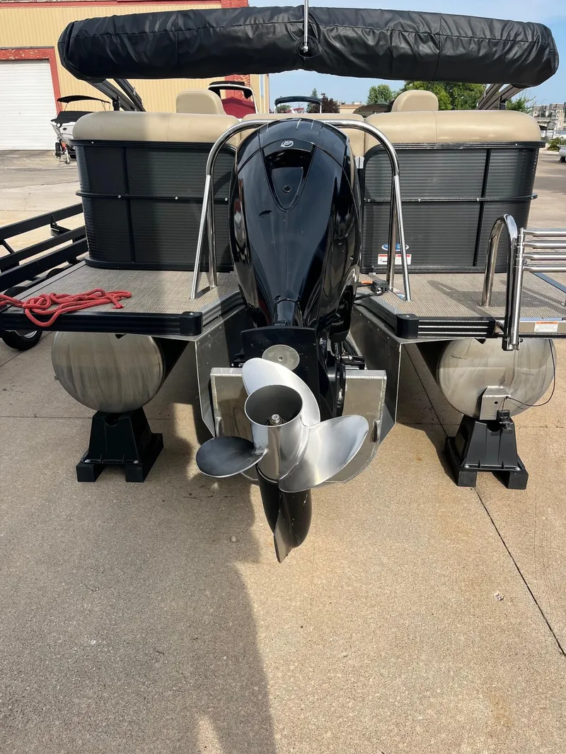 Slide: The Image of 2018 Manitou 23 Oasis RF VP pontoon boat with outboard motor, docked on concrete. - 8