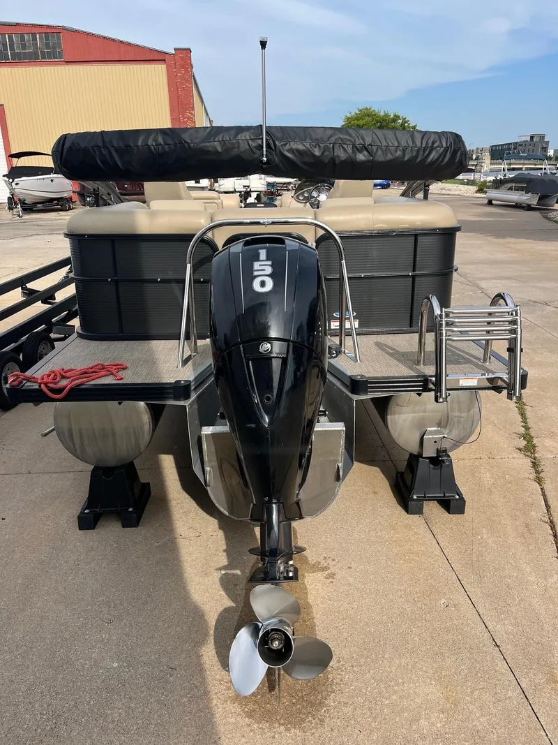 Slide: The Image of 2018 Manitou 23 Oasis RF VP pontoon boat with 150 HP engine, docked outdoors. - 9