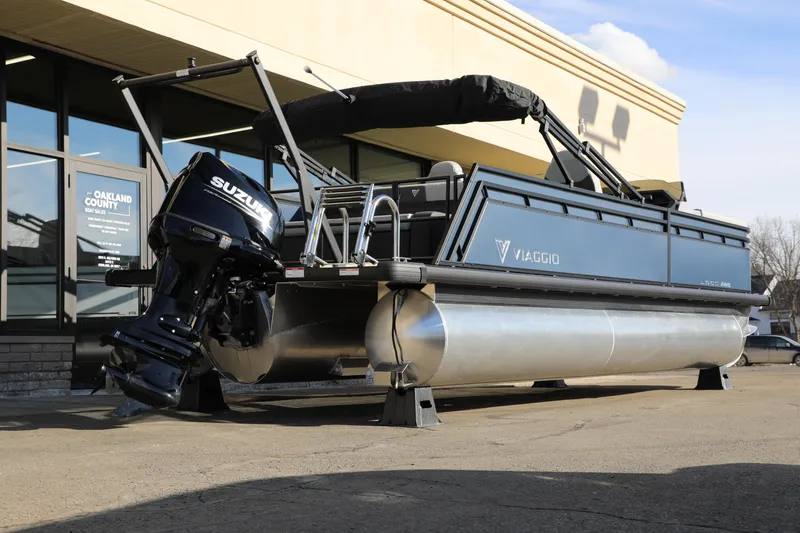 Slide: The Image of 2025 Viaggio Lago X22S pontoon boat with Suzuki outboard motor displayed outdoors. - 14