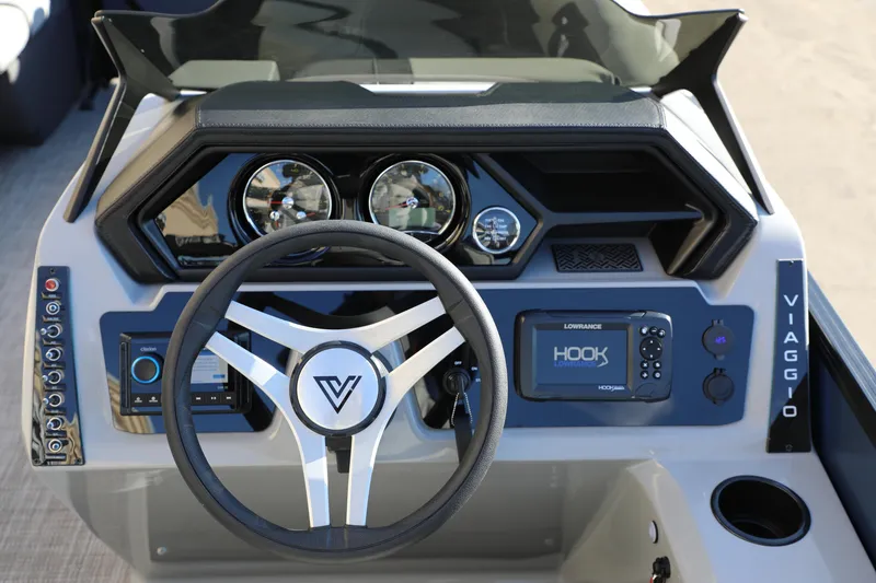 Slide: The Image of 2025 Viaggio Lago X22S dashboard with steering wheel, gauges, and navigation system. - 2