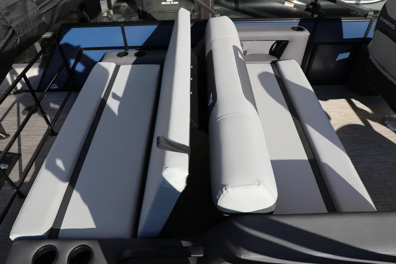 Slide: The Image of 2025 Viaggio Lago X22S boat interior with gray cushioned seating and cup holders. - 3
