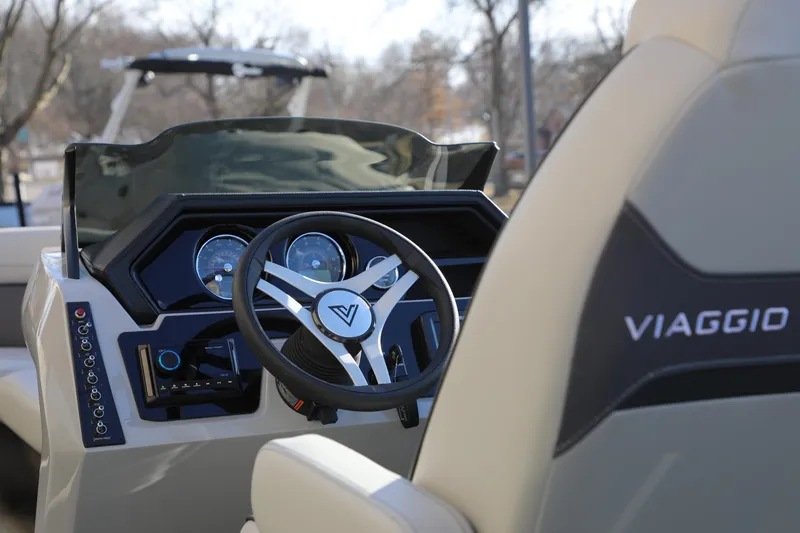 Slide: The Image of 2025 Viaggio Lago X22S boat dashboard with steering wheel and controls. - 6
