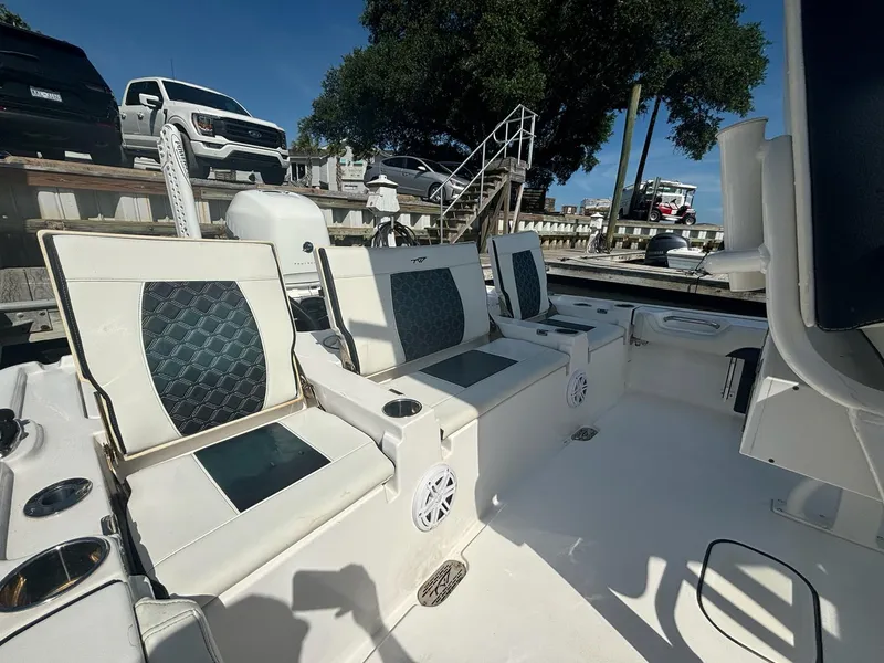 Slide: The Image of 2023 Tidewater 2500CB boat interior with stylish seating and cup holders. - 13