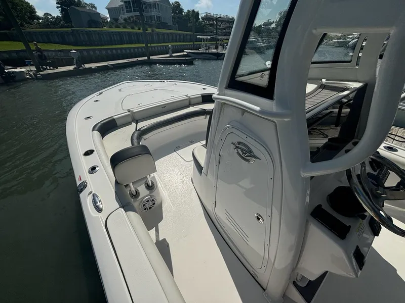 Slide: The Image of 2023 Tidewater 2500CB boat docked, showcasing sleek design and spacious deck. - 16