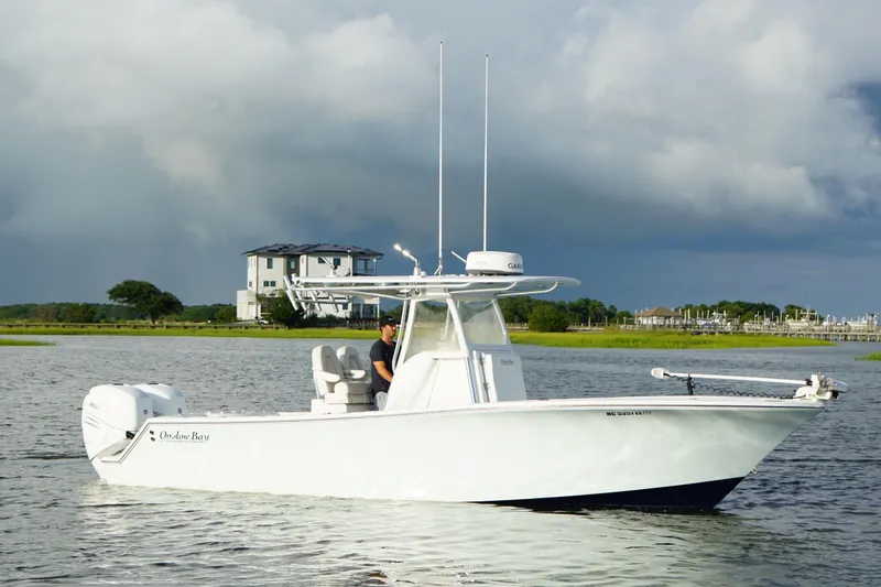 Slide: The Image of 2017 Onslow Bay 27 boat on calm water with scenic background. - 15