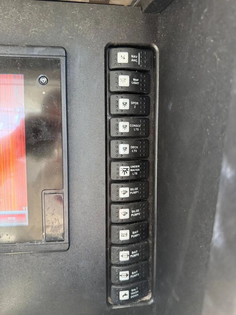 Slide: The Image of Control panel of a 2017 Onslow Bay 27 boat with labeled switches. - 8