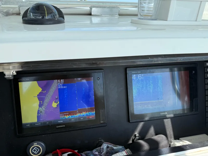 Slide: The Image of Boat dashboard with dual Garmin GPS displays on a 2017 Onslow Bay 27. - 12