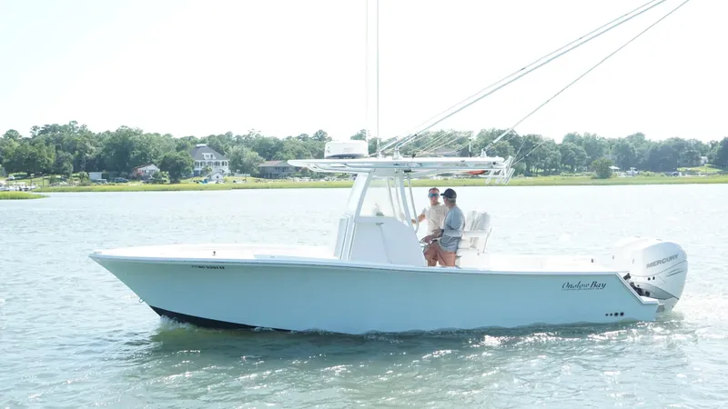 Slide: The Image of 2017 Onslow Bay 27 boat cruising on a sunny day with two people onboard. - 13