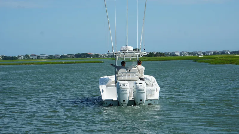 Slide: The Image of 2017 Onslow Bay 27 boat cruising on a calm waterway with two people onboard. - 16