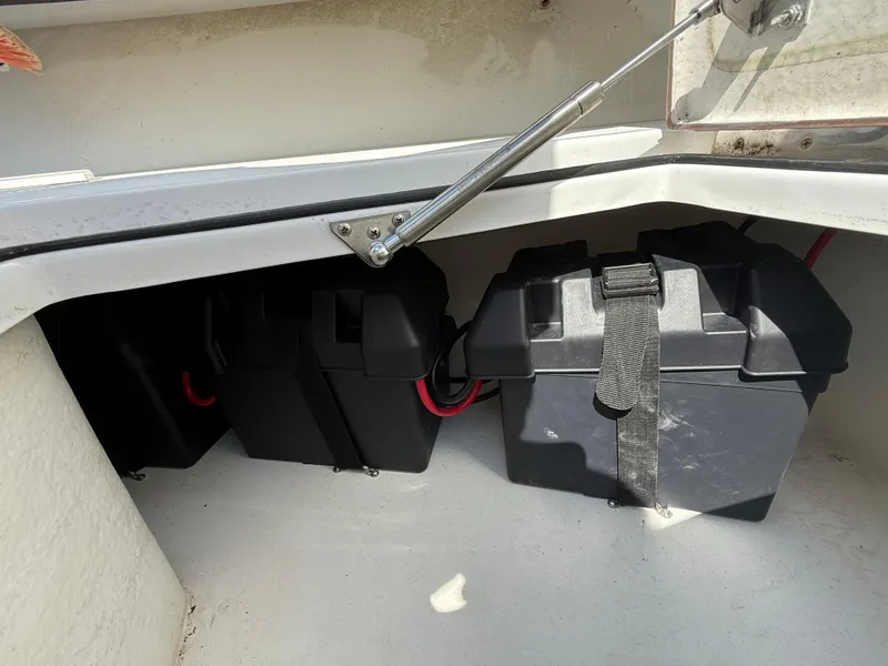 Slide: The Image of Battery compartment of a 2017 Onslow Bay 27 boat, featuring secured black battery boxes. - 9