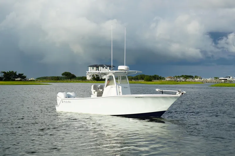 Slide: The Image of 2017 Onslow Bay 27 boat on calm water with cloudy sky backdrop. - 1