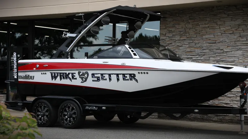 Slide: The Image of 2013 Malibu Wakesetter 20 VTX boat on trailer, parked outside a building. - 8