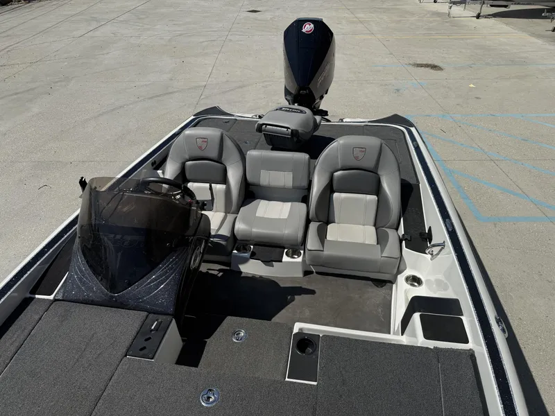 Slide: The Image of 2023 Triton 19 TrX Patriot boat interior with dual seats and steering console. - 11