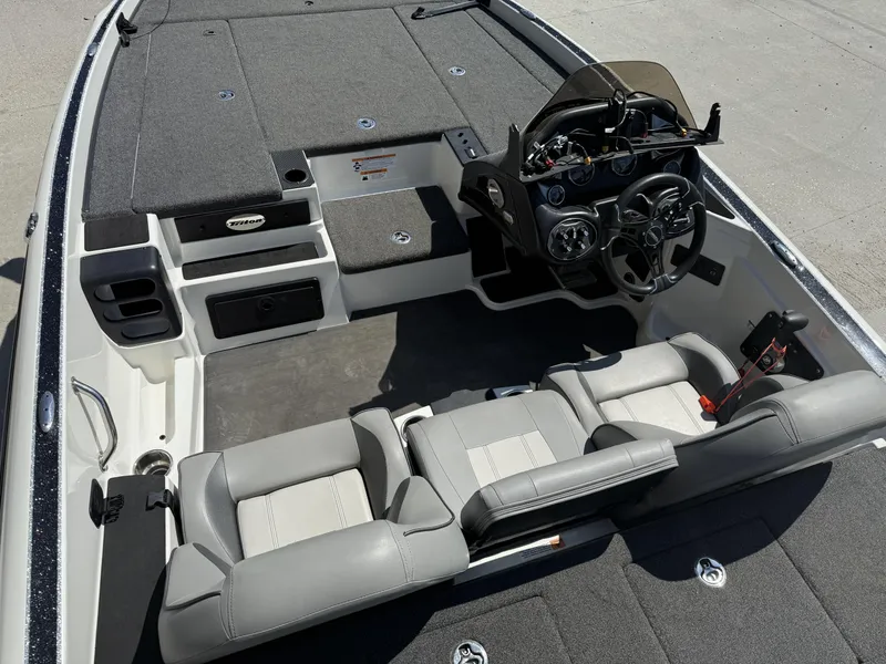 Slide: The Image of 2023 Triton 19 TrX Patriot boat interior with steering console and seating. - 14