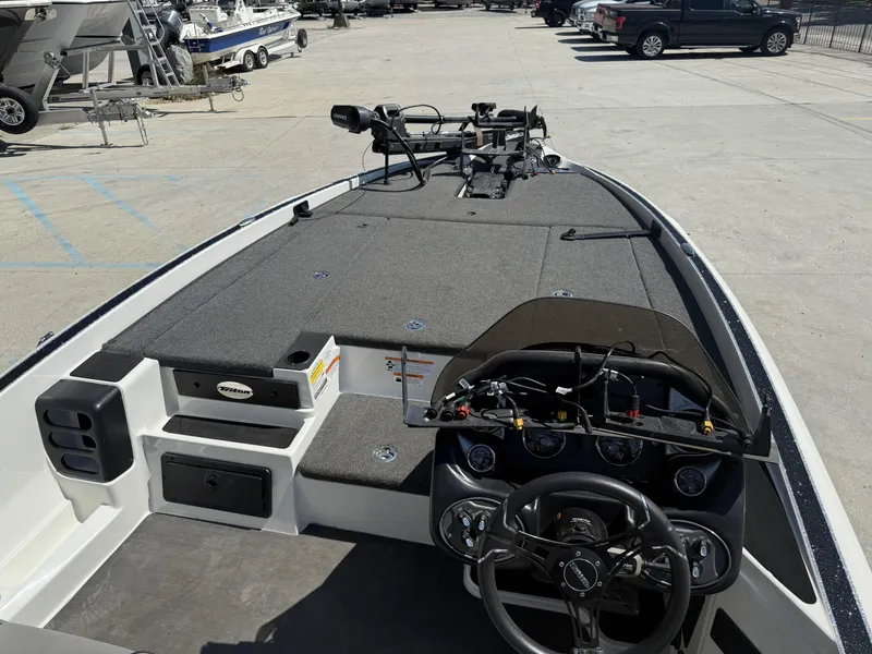 Slide: The Image of 2023 Triton 19 TrX Patriot boat interior with steering wheel and control panel. - 15