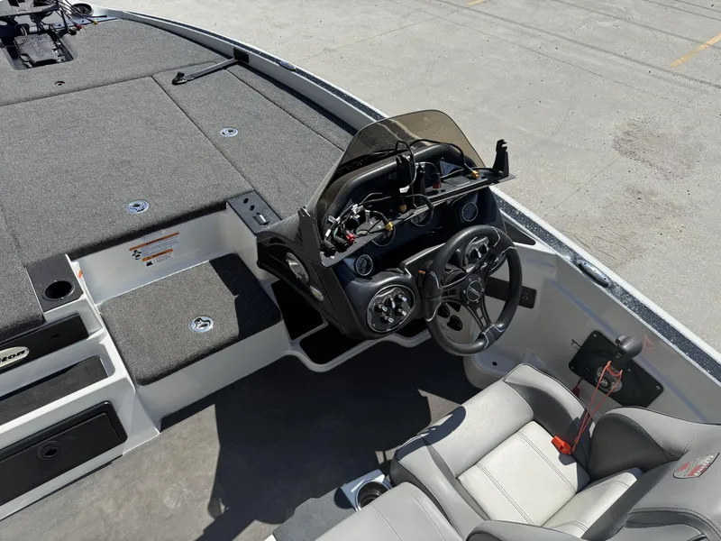 Slide: The Image of 2023 Triton 19 TrX Patriot boat interior with steering console and seating. - 23