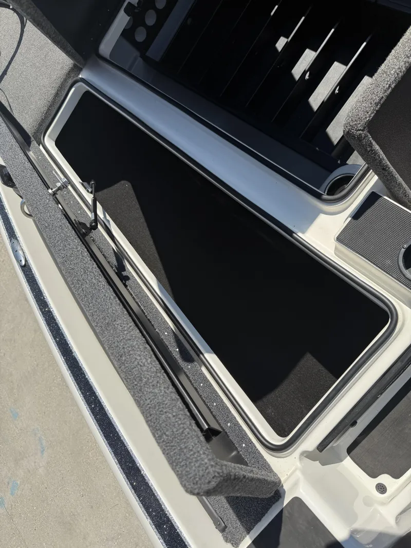 Slide: The Image of Open storage compartment in 2023 Triton 19 TrX Patriot boat, showcasing interior design. - 24