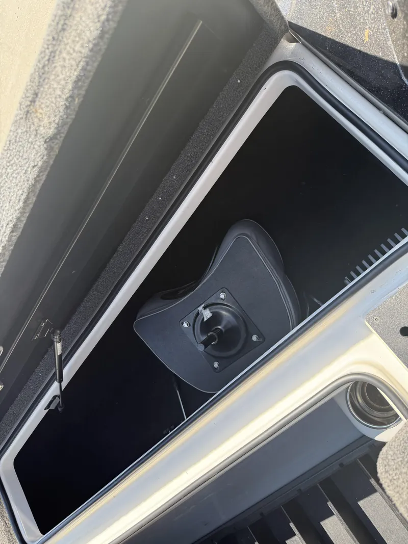 Slide: The Image of Open storage compartment in 2023 Triton 19 TrX Patriot boat. - 7