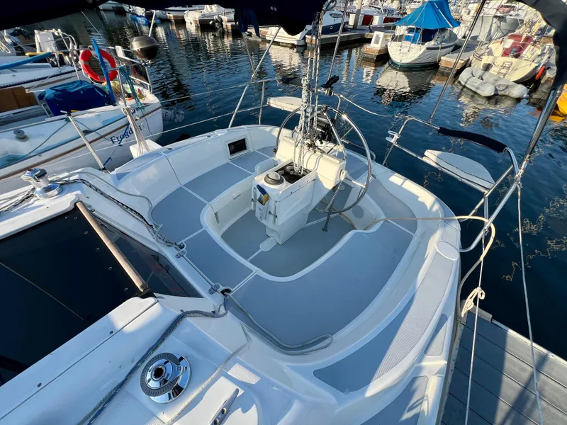 Slide: The Image of 1995 Hunter 29.5 sailboat cockpit at marina, featuring steering wheel and seating. - 16