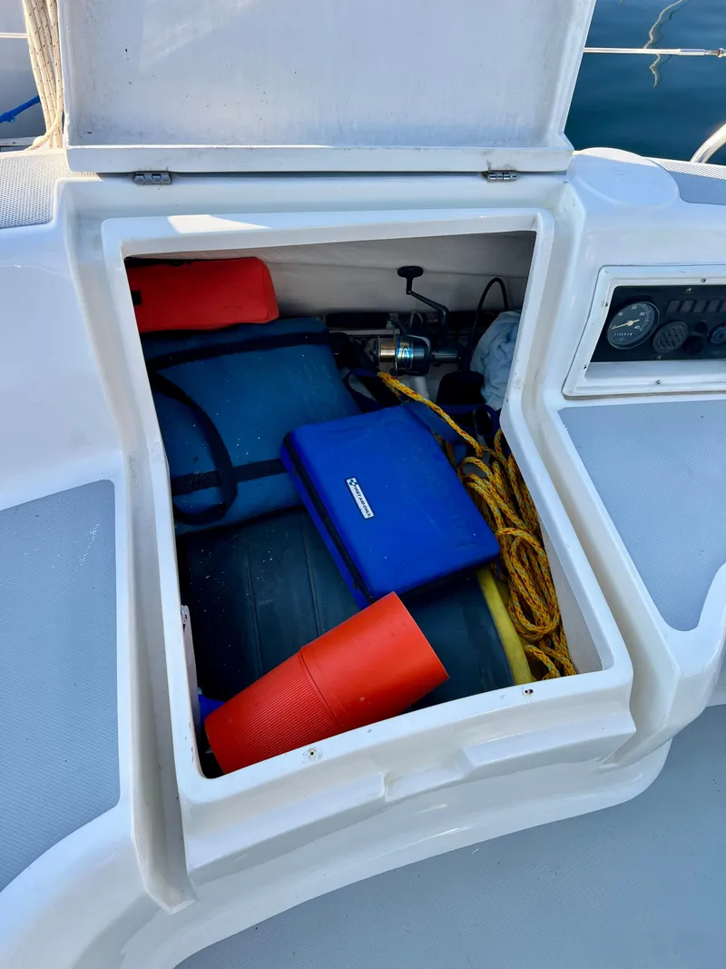Slide: The Image of Open storage compartment on 1995 Hunter 29.5 sailboat with equipment and rope. - 23