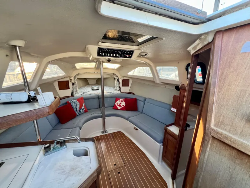 Slide: The Image of Interior of a 1995 Hunter 29.5 sailboat with cozy seating and nautical decor. - 27