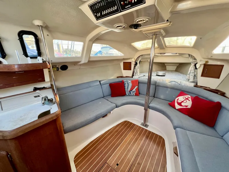 Slide: The Image of Interior of 1995 Hunter 29.5 sailboat with cozy seating and nautical decor. - 28