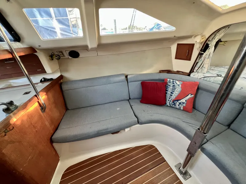 Slide: The Image of Interior of 1995 Hunter 29.5 sailboat with cozy seating and decorative pillows. - 32