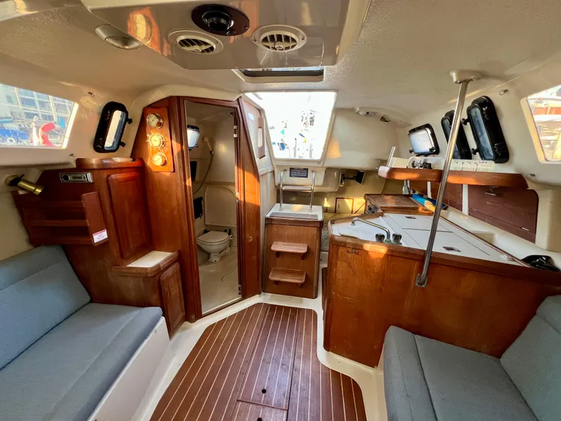 Slide: The Image of Interior of a 1995 Hunter 29.5 sailboat with wood finishes and seating. - 33