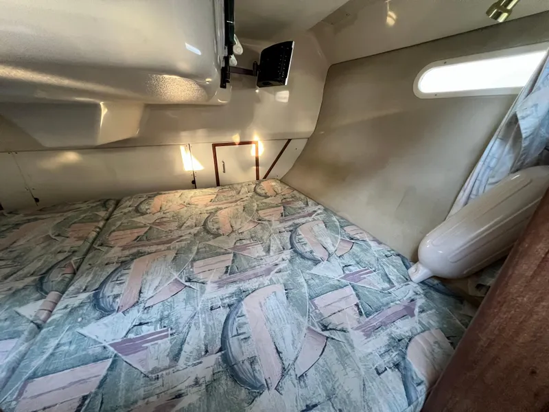 Slide: The Image of Interior cabin of a 1995 Hunter 29.5 sailboat with patterned bedding. - 36