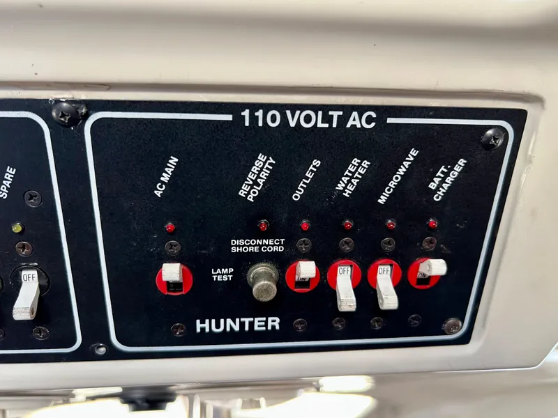 Slide: The Image of Electrical panel of a 1995 Hunter 29.5 boat with various switches and indicators. - 38