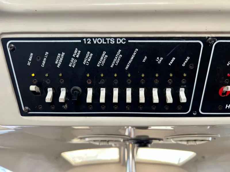 Slide: The Image of 1995 Hunter 29.5 boat control panel with switches for various functions. - 39