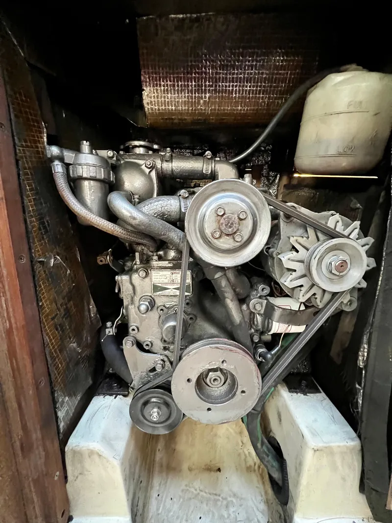 Slide: The Image of Engine compartment of a 1995 Hunter 29.5 sailboat, showing belts and components. - 41