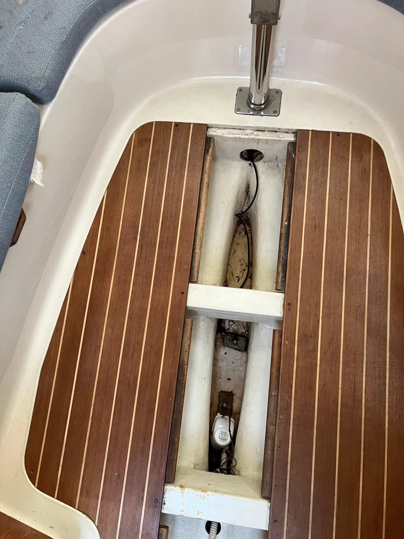 Slide: The Image of 1995 Hunter 29.5 sailboat interior with wooden flooring and visible bilge area. - 43