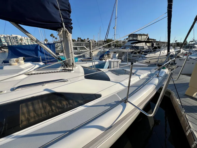 Slide: The Image of 1995 Hunter 29.5 sailboat docked in marina, surrounded by other boats. - 8