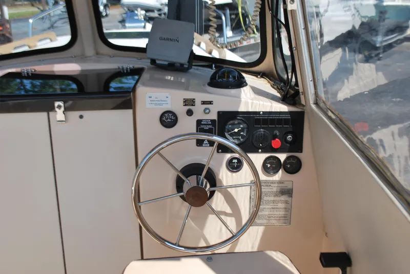 Slide: The Image of Interior view of 2001 Atlas Boat Works Pompano 21 helm with steering wheel and controls. - 10