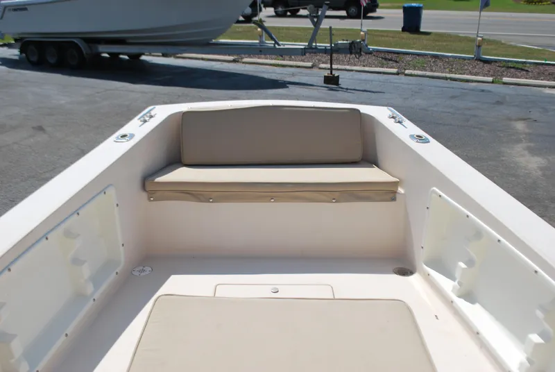 Slide: The Image of 2001 Atlas Boat Works Pompano 21 interior with beige seating and storage compartments. - 14