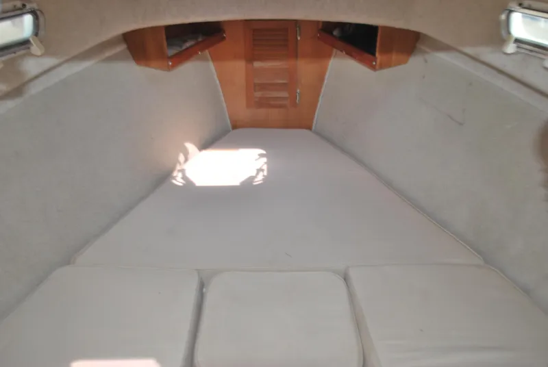 Slide: The Image of Interior cabin of 2001 Atlas Boat Works Pompano 21 with cushioned seating. - 16
