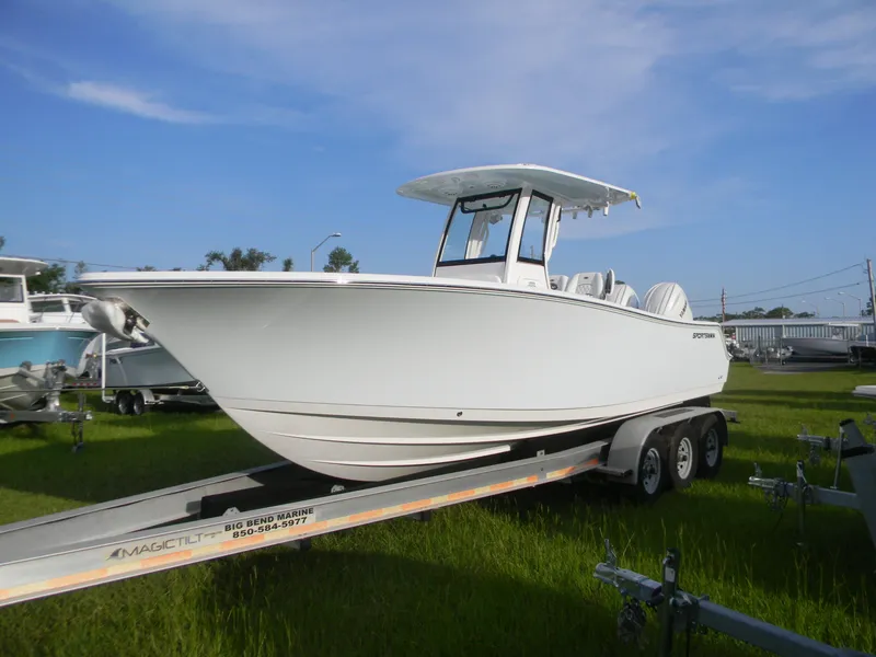 The Image of 2026 Sportsman Open 252 Center Console boat on trailer, displayed outdoors. - 1