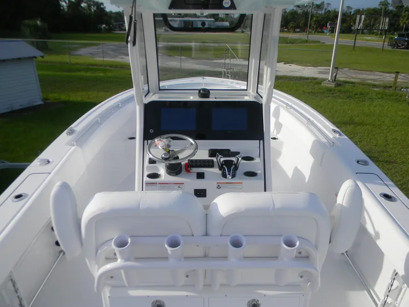 Slide: The Image of 2026 Sportsman Open 252 Center Console boat interior with steering wheel and dual screens. - 3